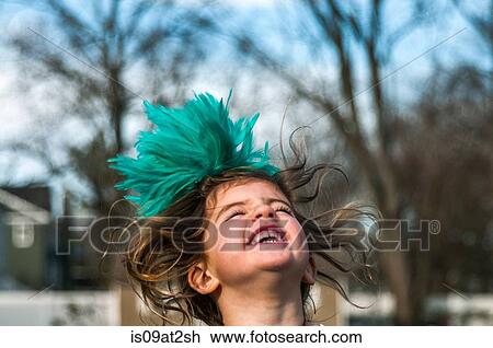 Stock Image - Girl with feather fascinator. Fotosearch