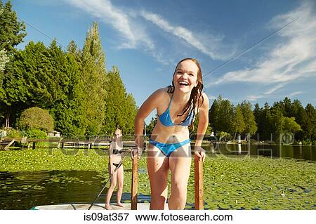 "Girls in bikini having fun at lake, Seattle, Washington, USA" View Large Photo Image Stock Photo - "Girls in bikini having fun at lake, Seattle, Washington, USA". Fotosearch