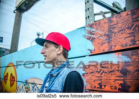 Stock Photography - "Graffiti artist by painted wall, Venice Beach, California, USA". Fotosearch