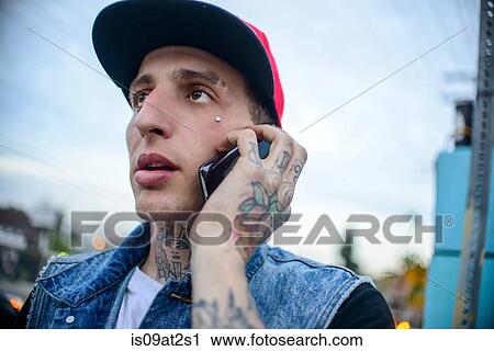 Stock Image - "Graffiti artist using smartphone, Venice Beach, California, USA". Fotosearch