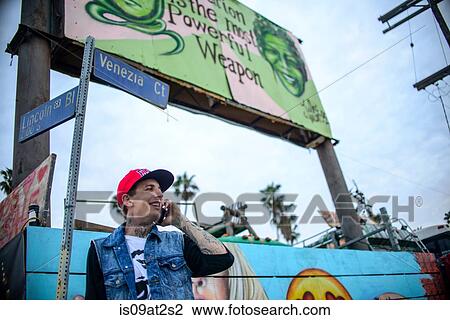 "Graffiti artist using smartphone under street signs, Venice Beach, California, USA" View Large Photo Image Stock Image - "Graffiti artist using smartphone under street signs, Venice Beach, California, USA". Fotosearch