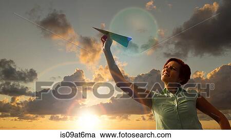 Low angle view of cloudscape and mid adult woman holding airplane made from map View Large Photo Image Stock Image - Low angle view of cloudscape and mid adult woman holding airplane made from map. Fotosearch