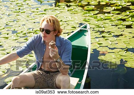 "Man eating on rowboat in lake, Seattle, Washington, USA" View Large Photo Image Stock Image - "Man eating on rowboat in lake, Seattle, Washington, USA". Fotosearch