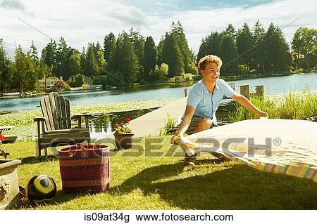 "Man laying picnic blanket on grass, lake in background, Seattle, Washington, USA" View Large Photo Image Stock Image - "Man laying picnic blanket on grass, lake in background, Seattle, Washington, USA". Fotosearch