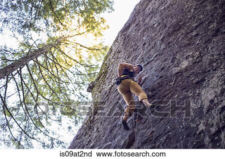 Stock Image - "Man rock climbing, French's Dome, Zig Zag, Oregon, USA". Fotosearch