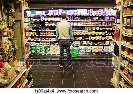 Picture - Man shopping in supermarket. Fotosearch