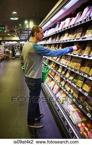 Stock Image - Man shopping in supermarket. Fotosearch