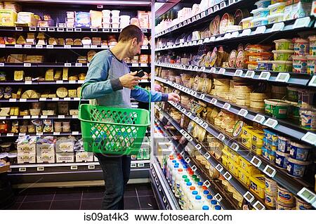 Man shopping in supermarket View Large Photo Image Stock Image - Man shopping in supermarket. Fotosearch