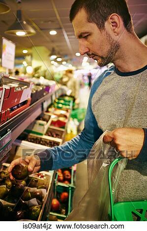 Stock Photo - Man shopping in supermarket. Fotosearch