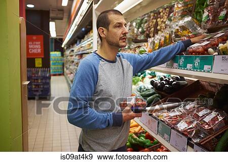 Man shopping in supermarket View Large Photo Image Stock Photo - Man shopping in supermarket. Fotosearch