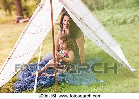 Mature woman and granddaughter sitting in homemade garden tent eating biscuits View Large Photo Image Stock Image - Mature woman and granddaughter sitting in homemade garden tent eating biscuits. Fotosearch