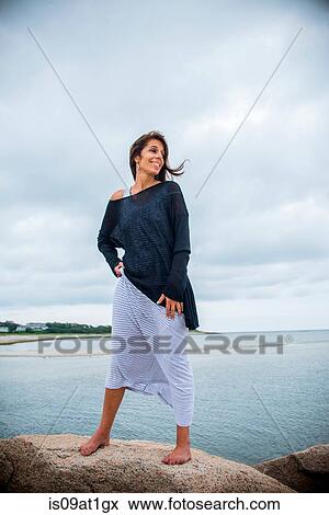 "Mature woman looking over her shoulder from coastal rocks, Cape Cod, USA" View Large Photo Image Stock Photo - "Mature woman looking over her shoulder from coastal rocks, Cape Cod, USA". Fotosearch