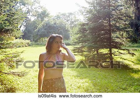 Mature woman looking sideways from sunlit park View Large Photo Image Stock Photograph - Mature woman looking sideways from sunlit park. Fotosearch