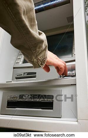 "Mid adult man using cash machine, focus on hands" View Large Photo Image Stock Photograph - "Mid adult man using cash machine, focus on hands". Fotosearch