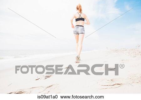 "Mid adult woman power walking on beach, rear view, low angle view" View Large Photo Image Stock Image - "Mid adult woman power walking on beach, rear view, low angle view". Fotosearch