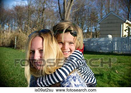 Mother giving piggyback to son in superhero costume View Large Photo Image Stock Photograph - Mother giving piggyback to son in superhero costume. Fotosearch