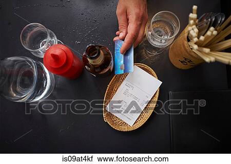 Overhead view of man paying with credit card View Large Photo Image Stock Image - Overhead view of man paying with credit card. Fotosearch