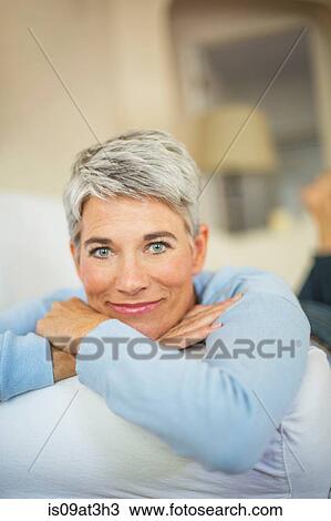 Stock Image - Portrait of beautiful mature woman with short grey hair and blue eyes. Fotosearch