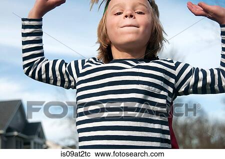 Stock Image - Portrait of boy in striped tee shirt outdoors. Fotosearch