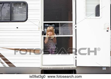 Stock Image - Portrait of girl at caravan door. Fotosearch