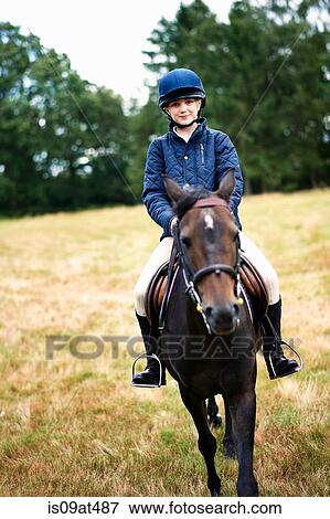 Portrait of girl horseback riding in field View Large Photo Image Stock Photo - Portrait of girl horseback riding in field. Fotosearch