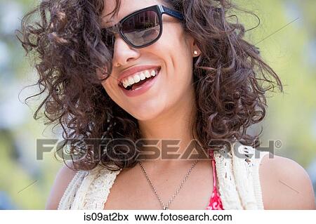 Portrait of happy young woman in garden View Large Photo Image Stock Photo - Portrait of happy young woman in garden. Fotosearch