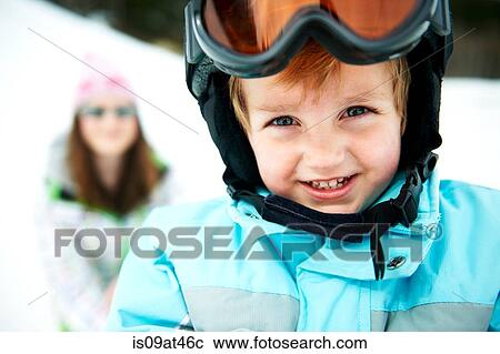 Stock Image - Portrait of male toddler wearing ski helmet. Fotosearch