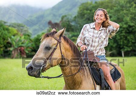 Portrait of mature woman on horseback View Large Photo Image Stock Photo - Portrait of mature woman on horseback. Fotosearch