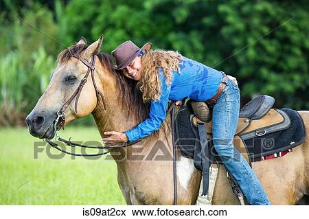 "Portrait of mature woman, on horseback, hugging horse" View Large Photo Image Stock Photo - "Portrait of mature woman, on horseback, hugging horse". Fotosearch