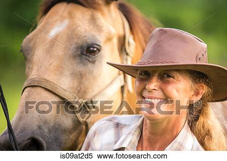Stock Photography - "Portrait of mature woman with horse, close-up". Fotosearch