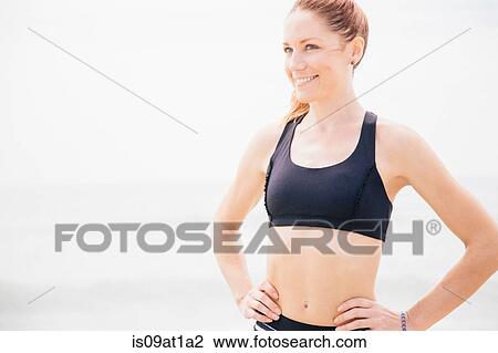 "Portrait of mid adult woman standing on beach, hands on hips" View Large Photo Image Stock Image - "Portrait of mid adult woman standing on beach, hands on hips". Fotosearch