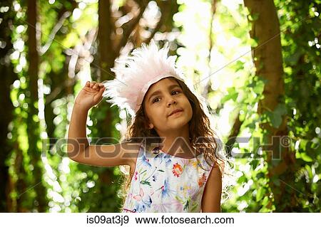 Portrait of pretty girl wearing feather headdress in forest View Large Photo Image Stock Photo - Portrait of pretty girl wearing feather headdress in forest. Fotosearch