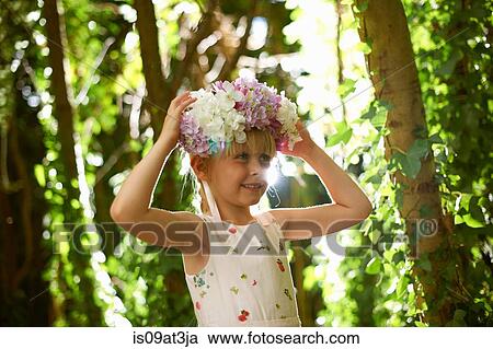 Portrait of pretty girl wearing flower headdress in forest View Large Photo Image Stock Image - Portrait of pretty girl wearing flower headdress in forest. Fotosearch