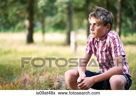 Portrait of teenage boy gazing from woodland View Large Photo Image Stock Photo - Portrait of teenage boy gazing from woodland. Fotosearch