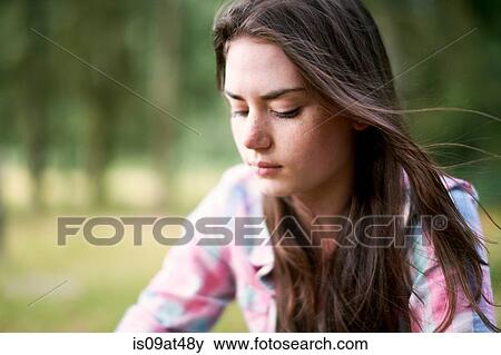 Portrait of teenage girl looking downward in woodland View Large Photo Image Stock Photo - Portrait of teenage girl looking downward in woodland. Fotosearch