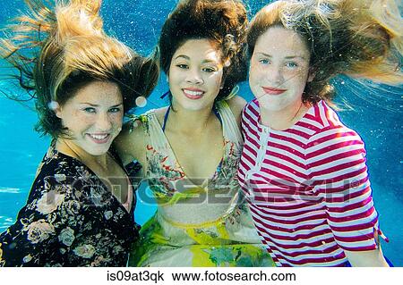 "Portrait of three female swimmers, underwater, smiling" View Large Photo Image Stock Image - "Portrait of three female swimmers, underwater, smiling". Fotosearch