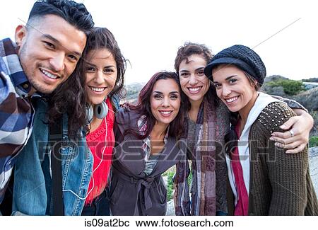 Stock Image - Portrait of young man and four adult sisters. Fotosearch