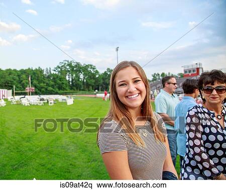 Stock Photography - "Portrait of young woman, smiling, outdoors". Fotosearch
