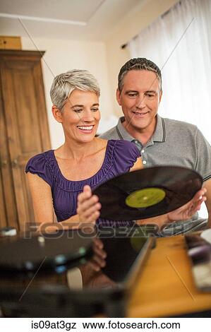 Romantic mature couple playing vinyl records View Large Photo Image Stock Photo - Romantic mature couple playing vinyl records. Fotosearch