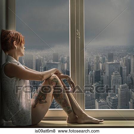 Side view of tattooed mid adult woman in window seat looking out of window at cityscape View Large Photo Image Stock Photo - Side view of tattooed mid adult woman in window seat looking out of window at cityscape. Fotosearch