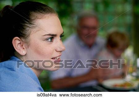 Side view of teenage girls head and shoulders looking away smiling View Large Photo Image Stock Image - Side view of teenage girls head and shoulders looking away smiling. Fotosearch