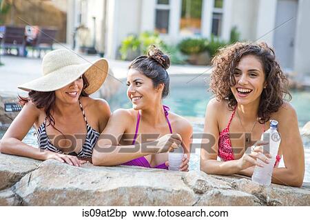 Three adult sisters wearing bikini tops chatting in garden View Large Photo Image Stock Photography - Three adult sisters wearing bikini tops chatting in garden. Fotosearch