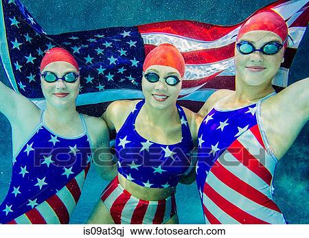 "Three female swimmers, underwater, wearing stars and stripes costumes, holding american flag" View Large Photo Image Stock Image - "Three female swimmers, underwater, wearing stars and stripes costumes, holding american flag". Fotosearch