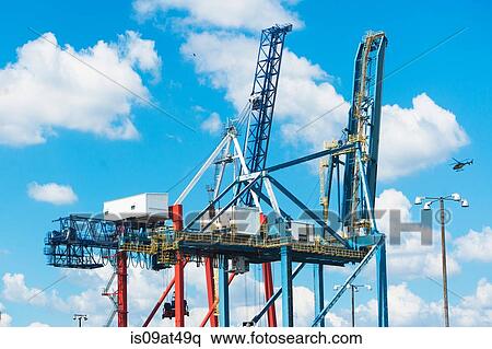 Two loading cranes against blue sky View Large Photo Image Stock Photography - Two loading cranes against blue sky. Fotosearch