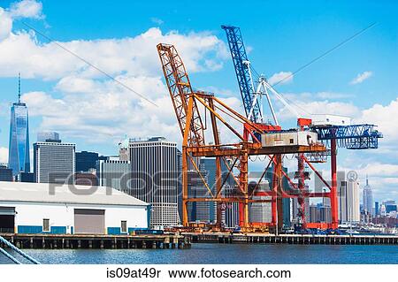 "Two loading cranes in harbor and New York skyline, New York, USA" View Large Photo Image Stock Photography - "Two loading cranes in harbor and New York skyline, New York, USA". Fotosearch