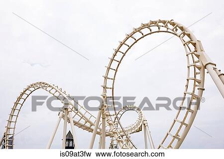 View of amusement park rollercoaster against grey sky View Large Photo Image Stock Photo - View of amusement park rollercoaster against grey sky. Fotosearch