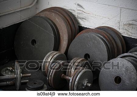 Weight plates and dumbbells View Large Photo Image Stock Photo - Weight plates and dumbbells. Fotosearch