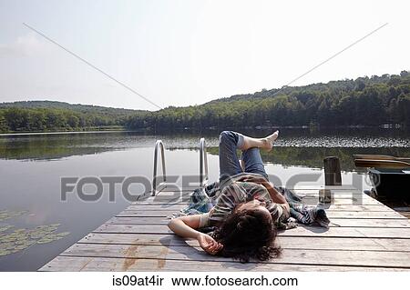 "Woman relaxing on lake pier, New Milford, Pennsylvania, USA" View Large Photo Image Stock Photography - "Woman relaxing on lake pier, New Milford, Pennsylvania, USA". Fotosearch
