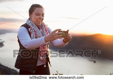 "Woman taking selfie on hill at sunset, Angel's Rest, Columbia River Gorge, Oregon, USA" View Large Photo Image Stock Image - "Woman taking selfie on hill at sunset, Angel's Rest, Columbia River Gorge, Oregon, USA". Fotosearch
