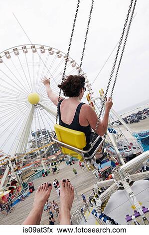 Woman waving from amusement park swings View Large Photo Image Stock Photo - Woman waving from amusement park swings. Fotosearch
